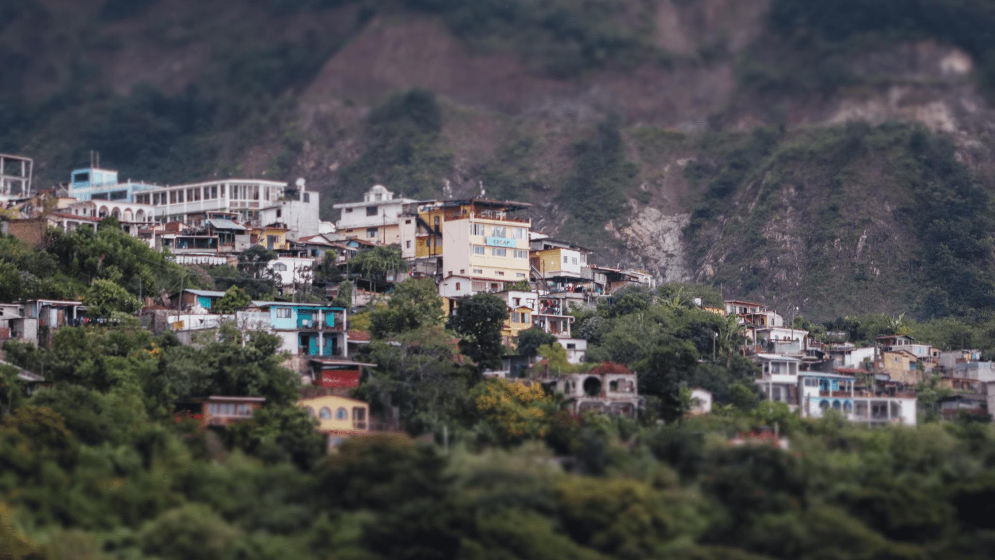 The village is nestled between two mountains on each side.