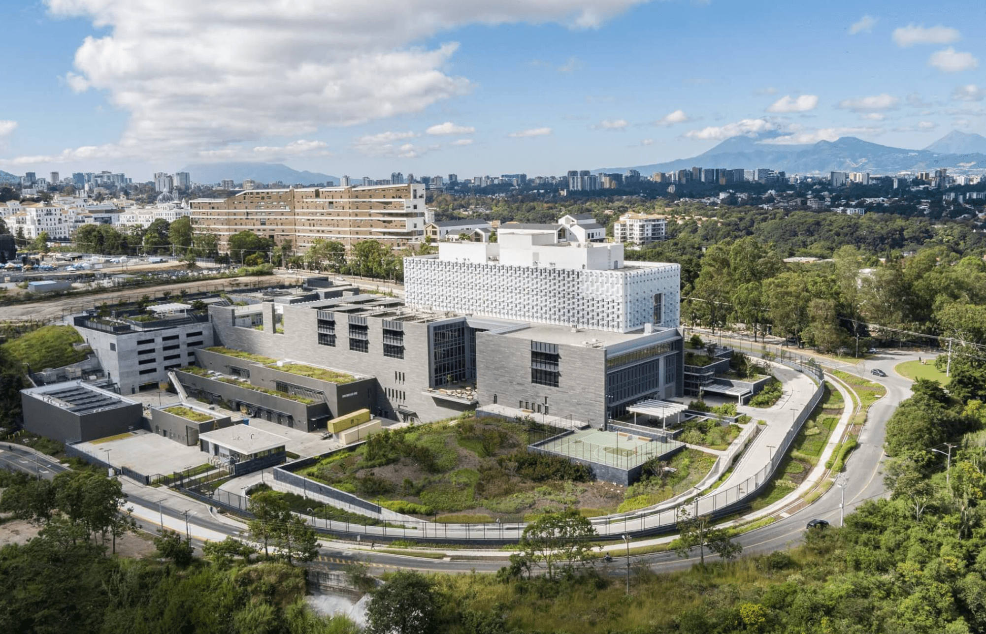A glass tower rises from the granite-clad base of the new U.S. embassy in Guatemala.
