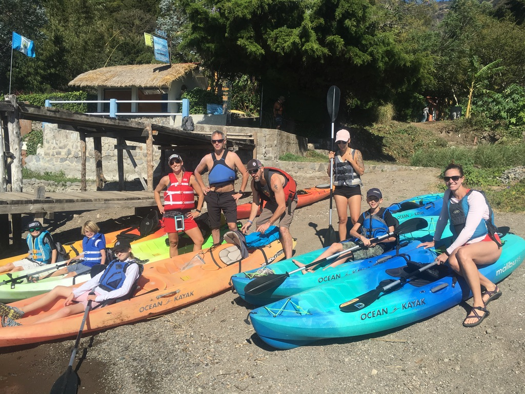 A family on vacation preparing for a kayak adventure. One of the many activities families can enjoy when visiting lake atitlan. 